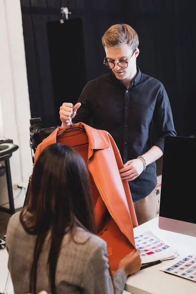 Selective Focus Stylist Showing Jacket Producer Backstage — Stock Photo, Image