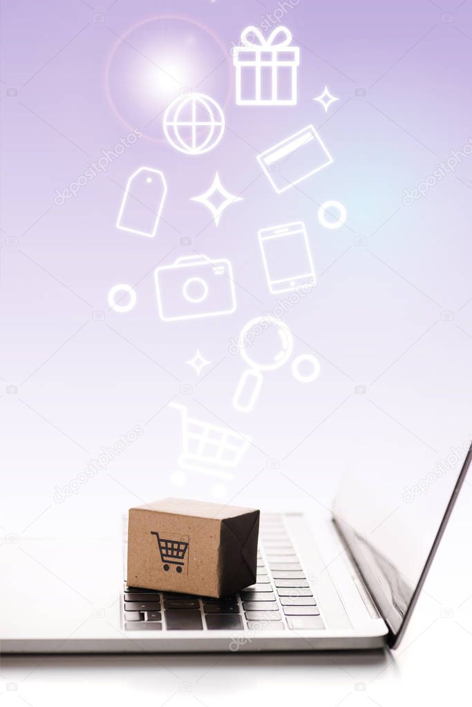 toy box on laptop keyboard near illustration on white, e-commerce concept