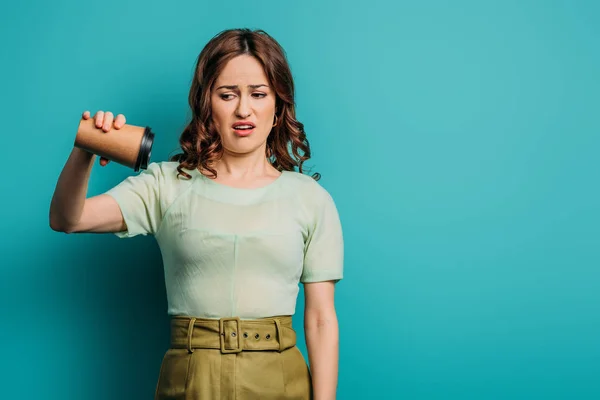 Displeased Woman Shaking Empty Paper Cup Blue Background — Stock Photo, Image