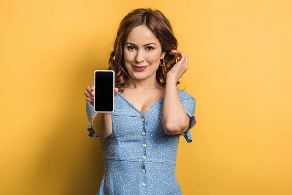 Flirty Girl Touching Hair While Showing Smartphone Blank Screen Yellow — Stock Photo, Image