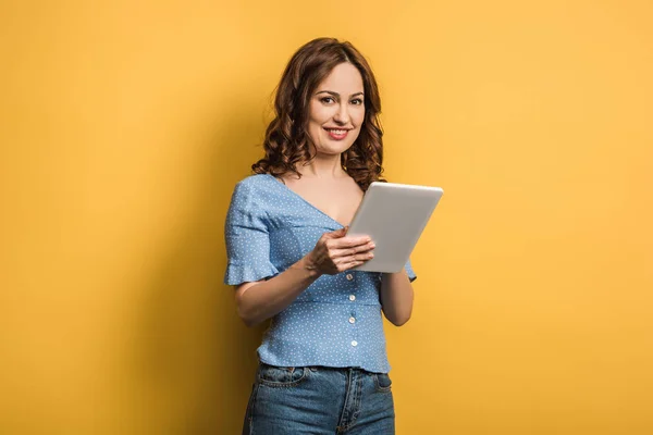 Young Woman Smiling Camera While Using Digital Tablet Yellow Background — 스톡 사진