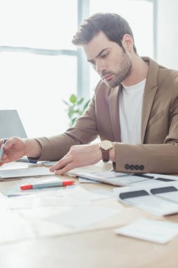 Masadaki ux ui uygulama geliştirme web sitesinin yakışıklı tasarımcı planlama çalışmalarının seçici odağı