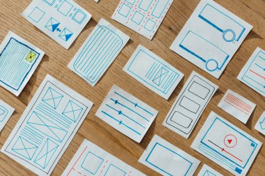 Top view of layouts of user experience design on wooden table clipart
