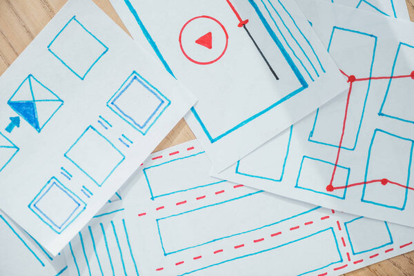 Top view of ux sketch layouts on wooden table