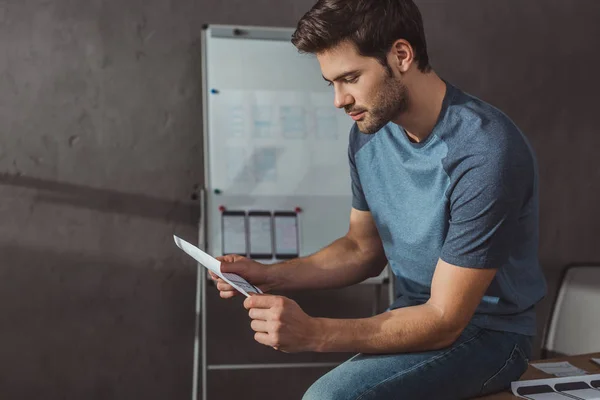 Side View Designer Holding Sketches While Sitting Table Office — 스톡 사진