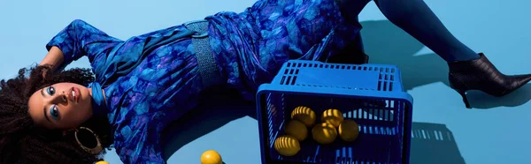 Panoramic Shot African American Woman Lying Shopping Basket Lemons Blue — 스톡 사진