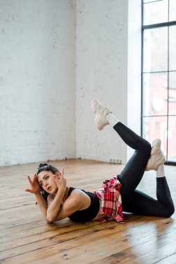 young flexible woman posing while dancing jazz funk  clipart