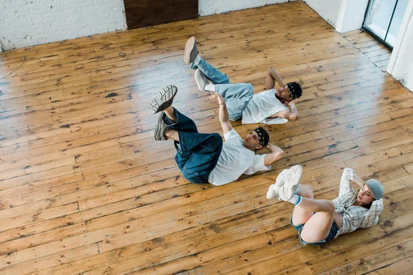 Overhead View Trendy Girl Lying Floor Multicultural Dancers While Breakdancing — 스톡 사진