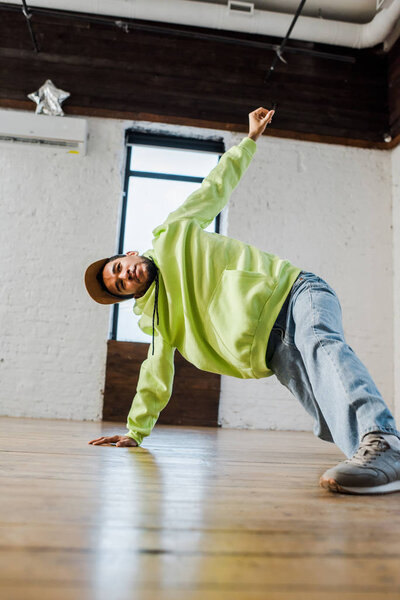 stylish african american dancer breakdancing in dance studio 