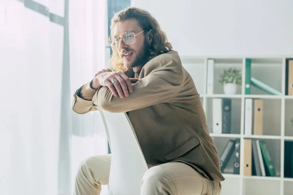 Sorrindo Elegante Homem Negócios Elegante Posando Cadeira Luz Sol Escritório — Fotografia de Stock