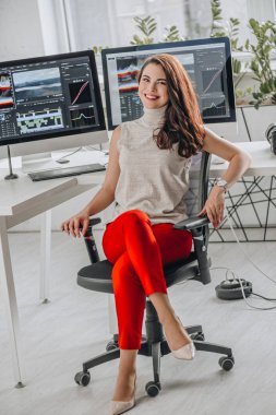 happy and attractive art editor near computer monitors  clipart