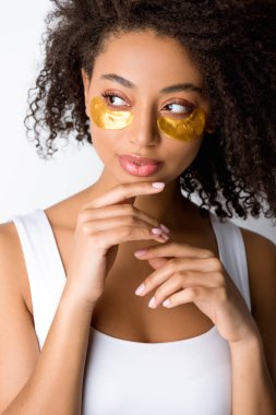 attractive curly african american girl with golden eye patches, isolated on grey clipart