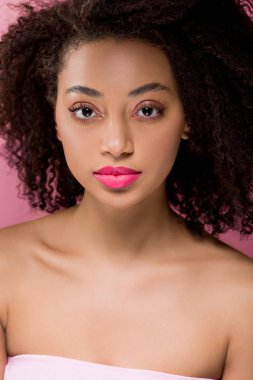 Pembe üzerine izole edilmiş güzel kıvırcık Afrikalı Amerikalı kızın portresi.