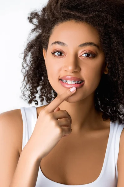 Pensive Smiling African American Girl Dental Braces Touching Lip Isolated — 스톡 사진