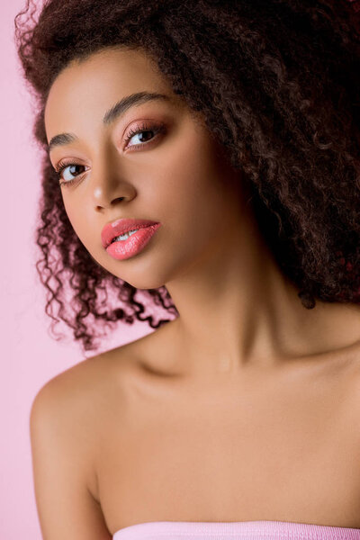 portrait of african american girl looking at camera, isolated on pink