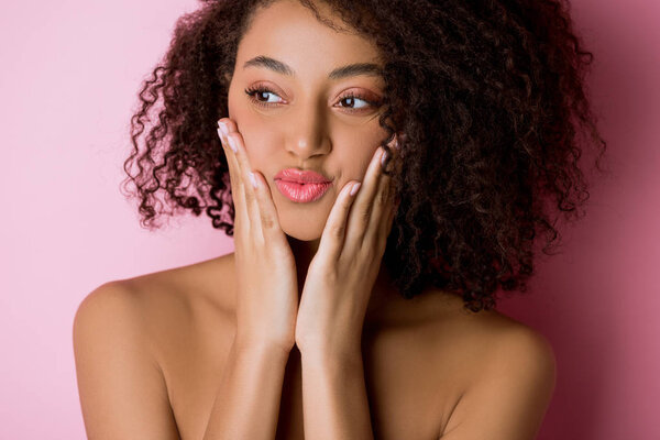 portrait of cheerful beautiful naked african american girl on pink