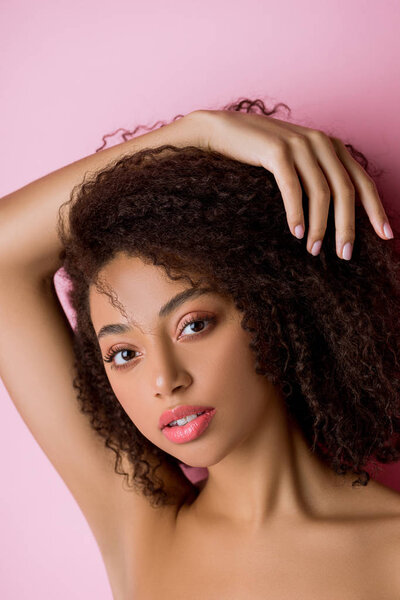 portrait of beautiful curly african american girl, isolated on pink