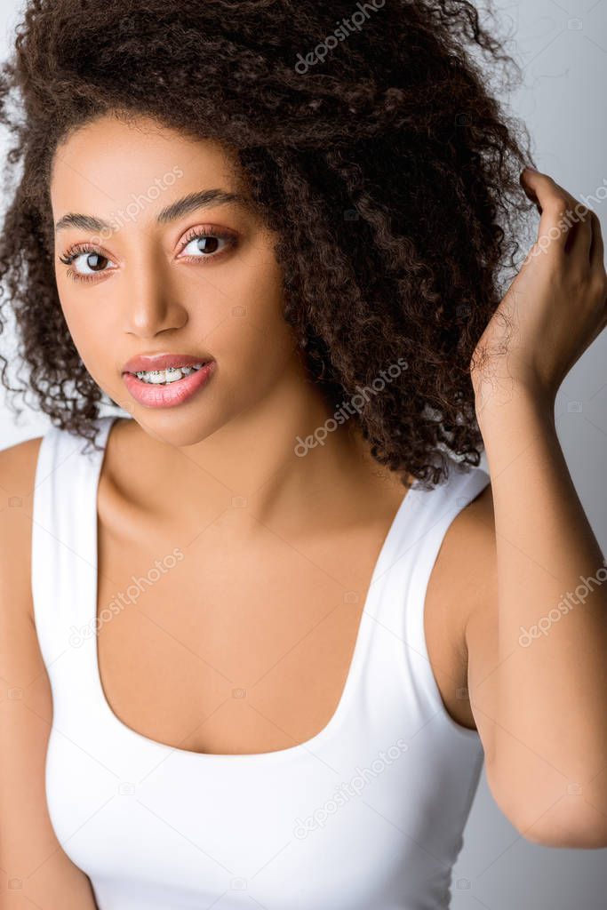attractive african american girl with dental braces, isolated on grey
