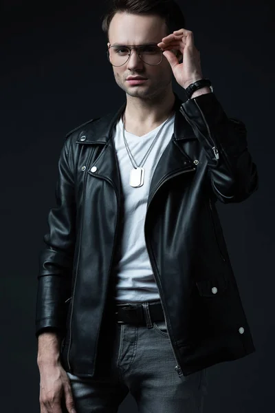 Stylish Brutal Man Biker Jacket Touching Eyeglasses Isolated Black — 스톡 사진