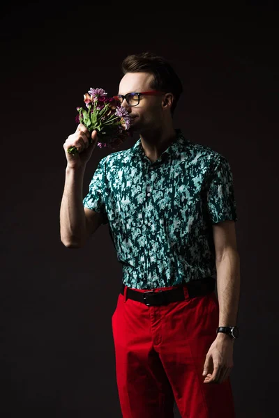 Fashionable Man Eyeglasses Blue Colorful Shirt Red Pants Smelling Floral — Stock Photo, Image