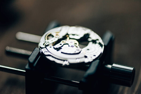 Close up view of open mechanical wristwatch on movement holder 
