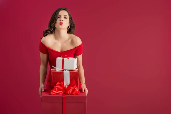 Flirty Elegant Girl Holding Gift Boxes While Sending Air Kiss — Stock Photo, Image