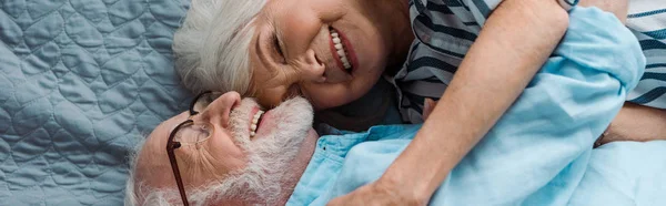 Vista Superior Sonriente Pareja Ancianos Abrazándose Cama Plano Panorámico — Foto de Stock