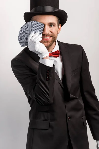 Positive Magician Holding Playing Cards Isolated Grey — Stock Photo, Image