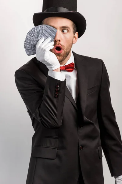 Shocked Magician Open Mouth Holding Playing Cards Isolated Grey — Stock Photo, Image