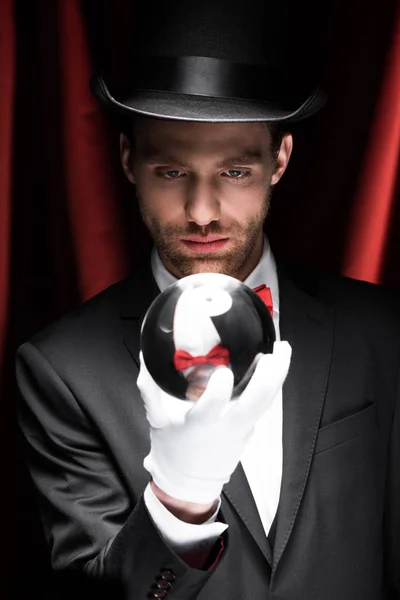 Young Magician Holding Magic Ball Circus Red Curtains — 스톡 사진