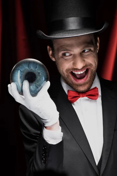 Excited Scary Magician Holding Blue Magic Ball Circus Red Curtains — Stock Photo, Image