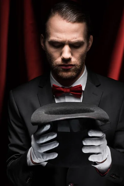 Focused Magician Suit Looking Hat Circus Red Curtains — Stock Photo, Image