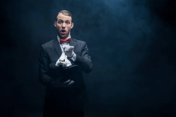 Shocked Magician Open Mouth Showing Trick White Rabbit Hat Dark — Stock Photo, Image