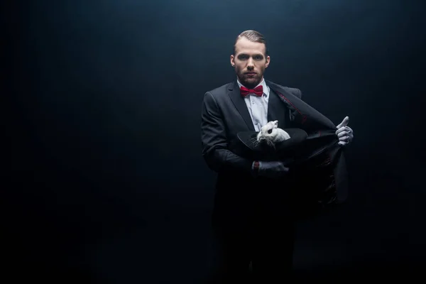 Young Magician Holding White Rabbit Hat Dark Room Smoke — Stock Photo, Image