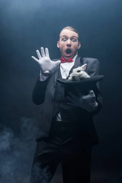 Shocked Magician Open Mouth Holding White Rabbit Hat Dark Room — Stock Photo, Image