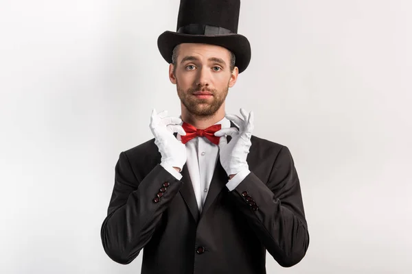 Confident Magician Adjusting Bow Tie Isolated Grey — 스톡 사진
