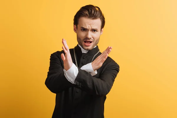 Displeased Catholic Priest Showing Stop Gesture Looking Camera Isolated Yellow — Stock Photo, Image