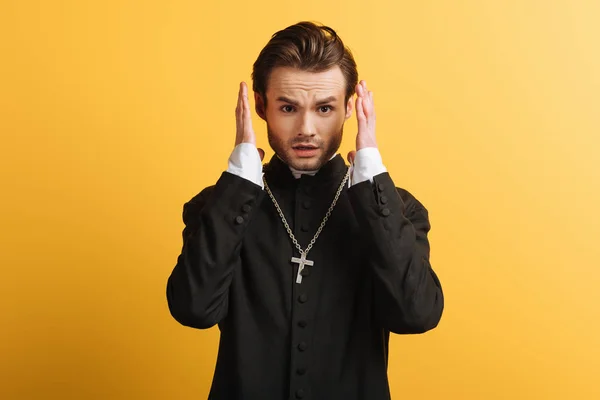 Shocked Catholic Priest Holding Hands Head Looking Camera Isolated Yellow — 图库照片