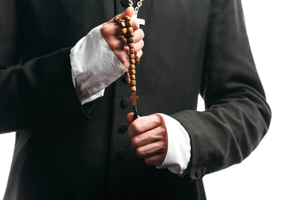 cropped view of catholic priest holding wooden rosary beads isolated on white