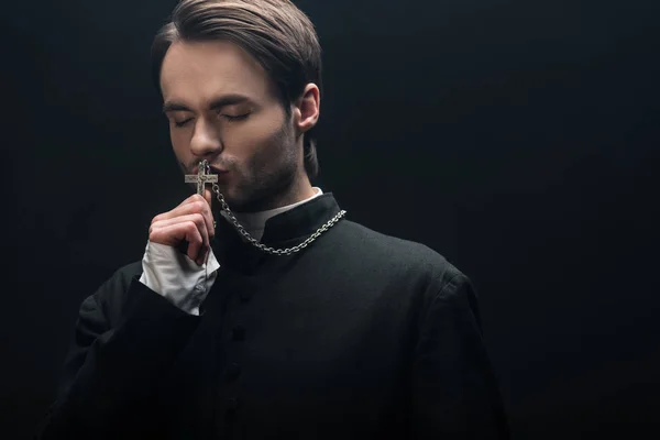 Young Thoughtful Catholic Priest Kissing Silver Cross Closed Eyes Isolated — Stock Photo, Image