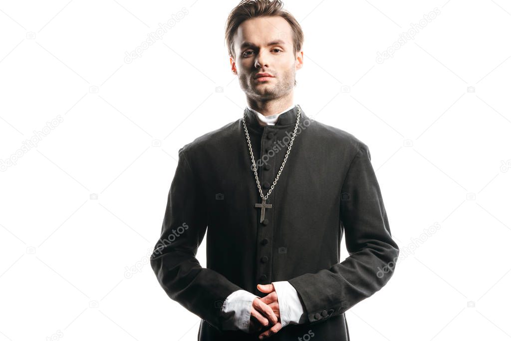 young, confident catholic priest looking at camera isolated on white