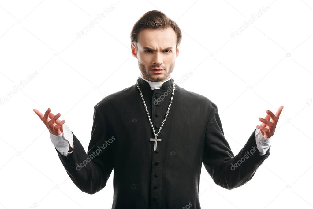 confident, serious catholic priest standing with open arms isolated on white