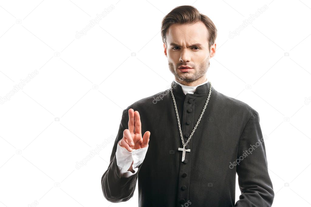 confident, strict catholic priest showing blessing gesture isolated on white