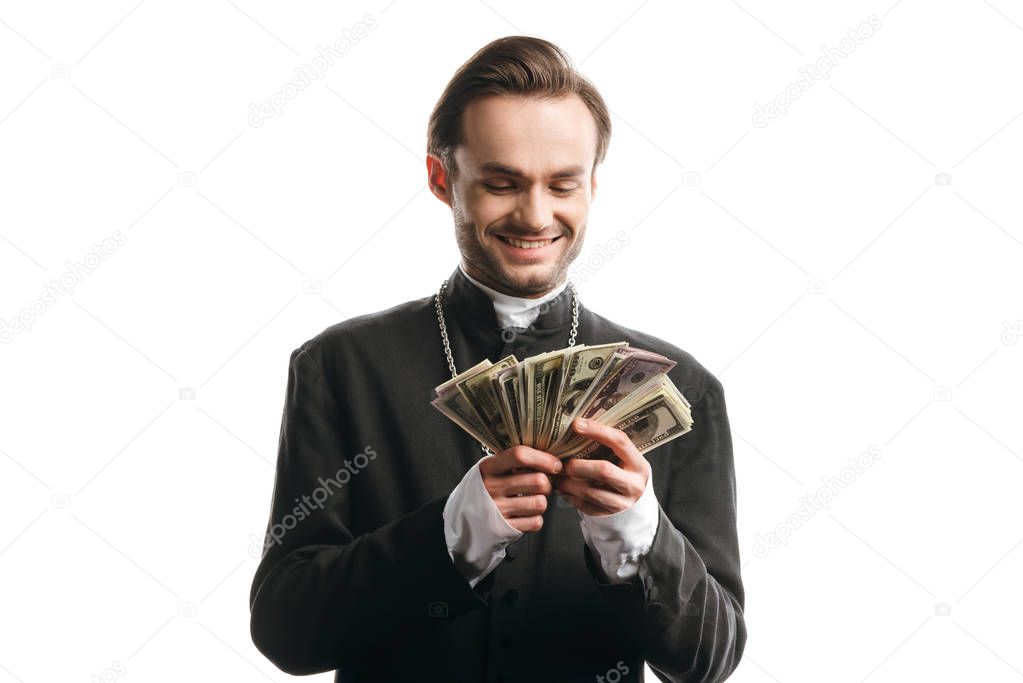corrupt catholic priest smiling while holding dollar banknotes isolated on white