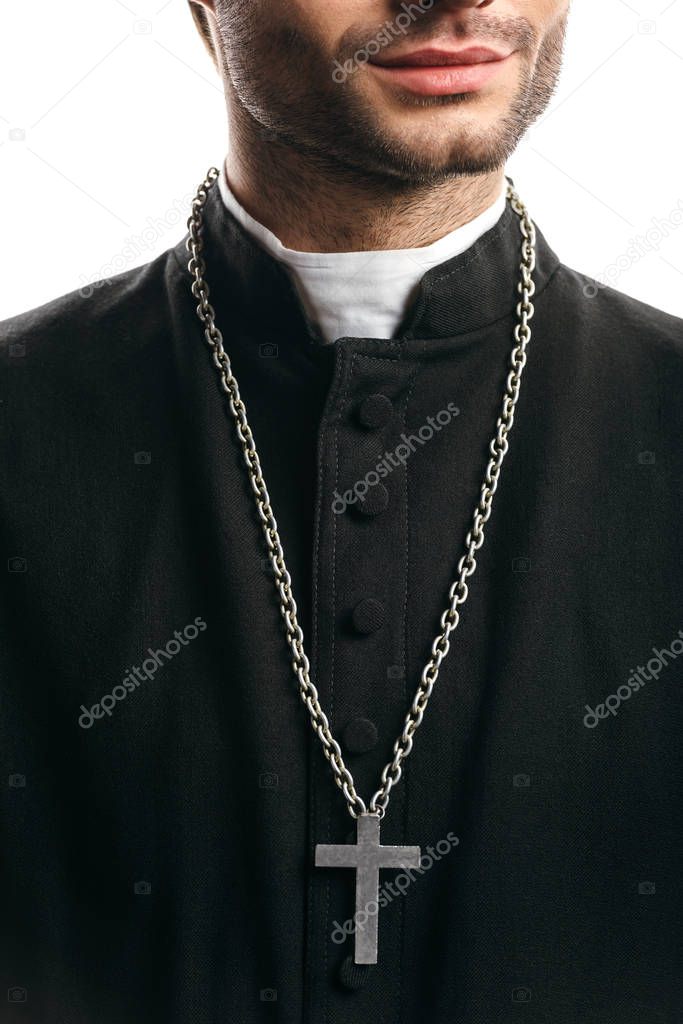 partial view of catholic priest in black cassock, with silver cross on necklace, isolated on white