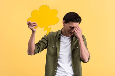 crying man holding cloud speech bubble, isolated on yellow