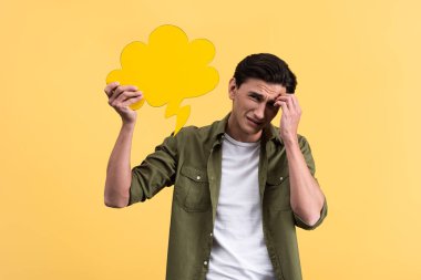 frustrated man holding cloud speech bubble, isolated on yellow