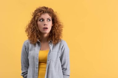 shocked beautiful girl with open mouth, isolated on yellow