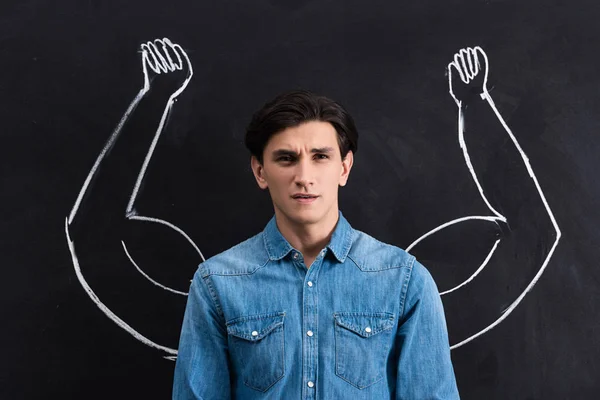 Pensive Young Man Strong Arms Drawing Blackboard — Stockfoto