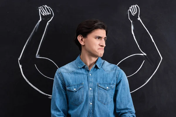 Emotional Young Man Strong Muscular Arms Drawing Blackboard — Stok fotoğraf